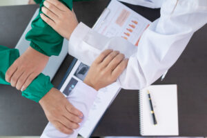 medical join hands with surgeon team to show confidence after medical has discussed cancer surgery plans with surgeon team. Collaborative concept of team of medical and surgeons in surgery.